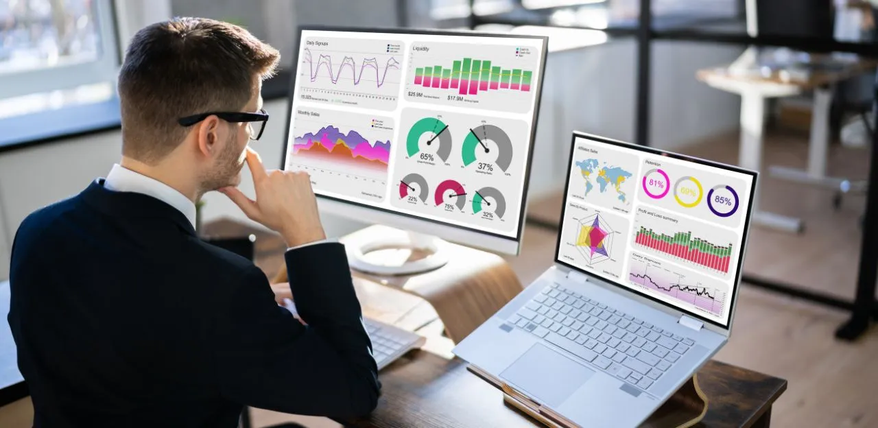 An expert data analyst team reviewing a complex data visualization dashboard, representing the best data analytics course in Bangalore.